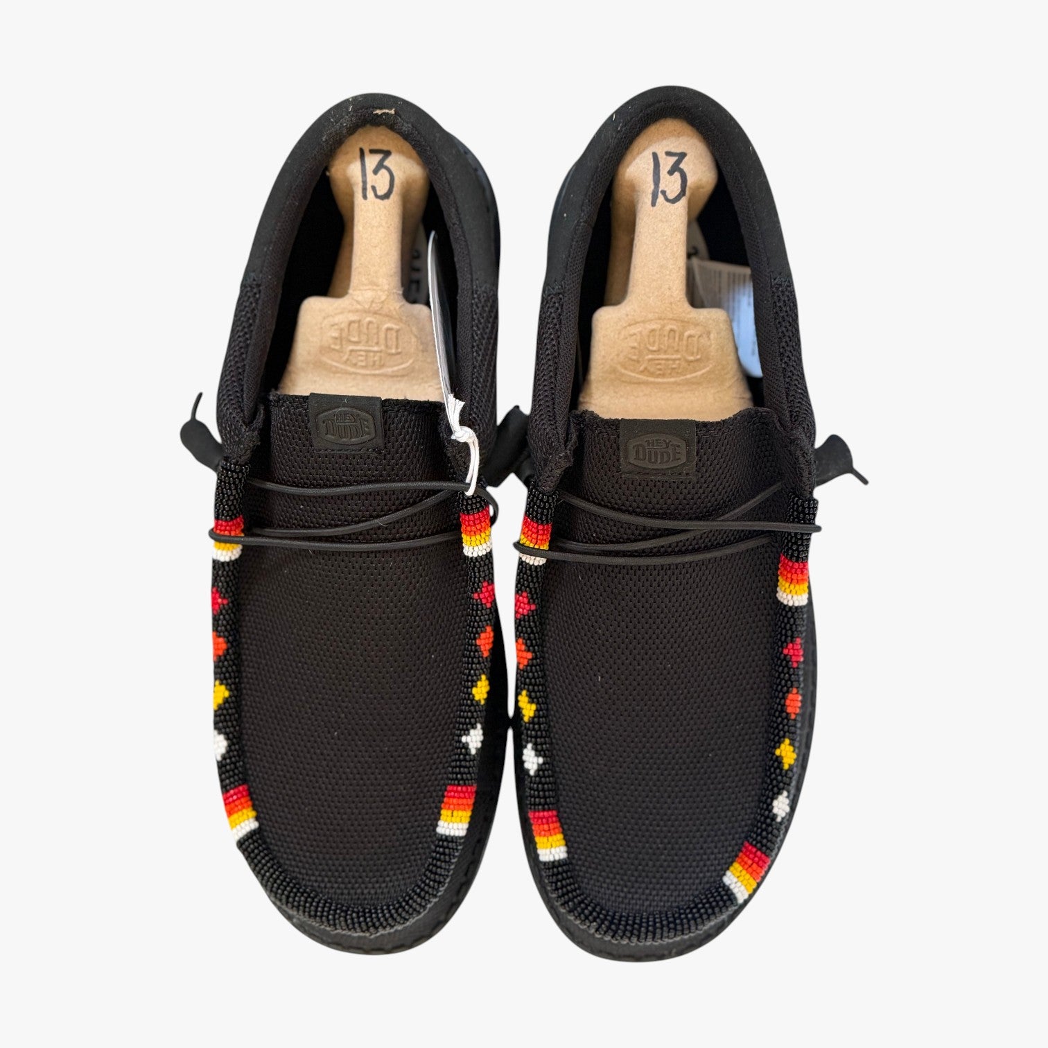 All Nations Designs & More men's black Hey Dude slip-on shoes featuring custom hand-beaded western-style patterns.