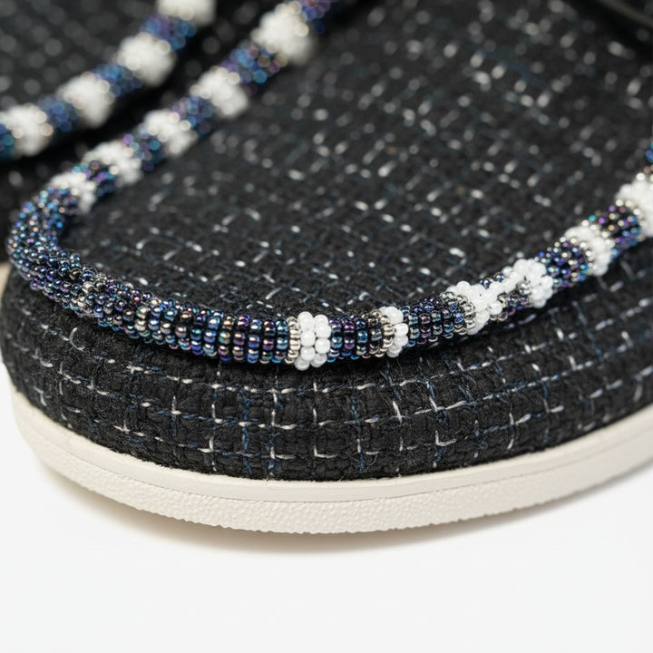 All Nations Designs &amp; More hand-beaded black mesh Hey Dude slip-on shoes with intricate white and iridescent beadwork.