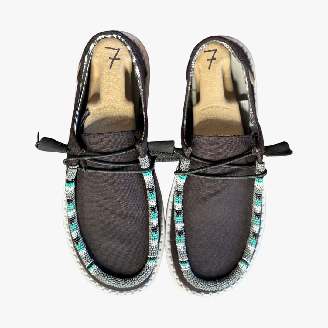 All Nations Designs &amp; More black Hey Dude slip-on shoes featuring custom hand-beaded trim in turquoise and white.