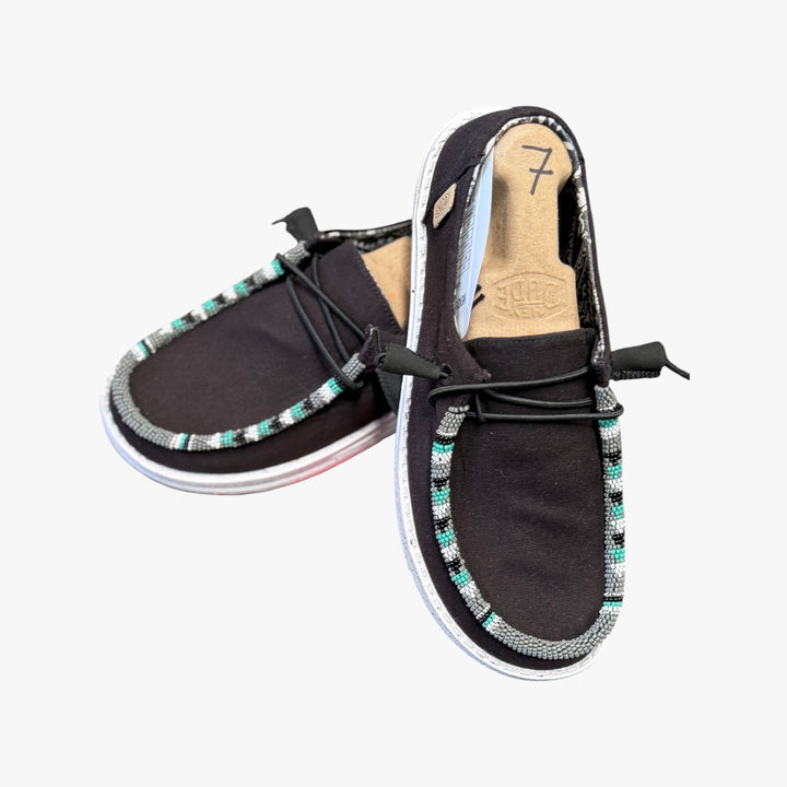 All Nations Designs &amp; More black Hey Dude slip-on shoes featuring custom hand-beaded trim in turquoise and white.