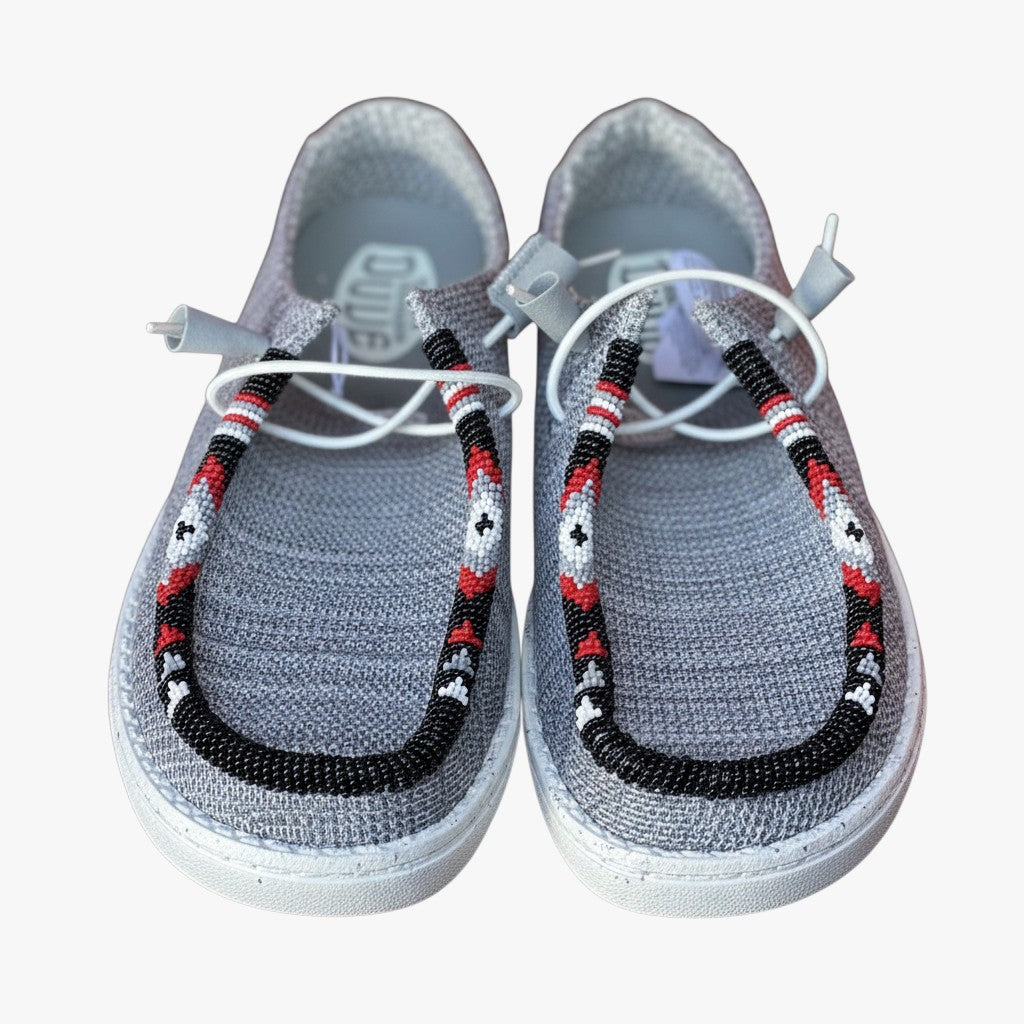 All Nations Designs &amp; More light gray Hey Dude slip-on shoes featuring custom red, black, and white hand-beaded trim.