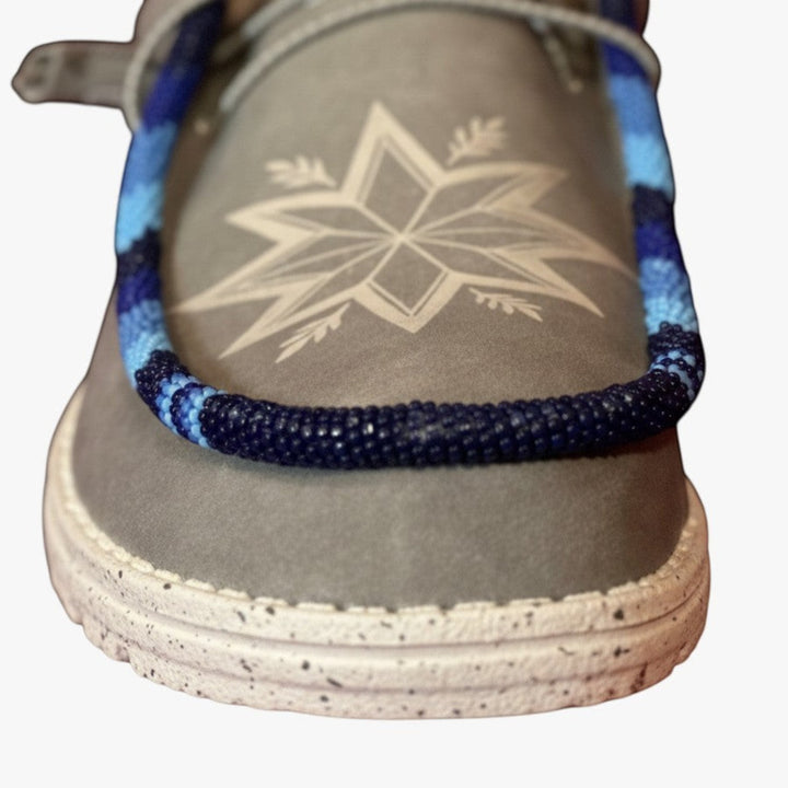All Nations Designs &amp; More light gray Hey Dude slip-on shoes featuring custom blue hand-beaded trim and star detail.