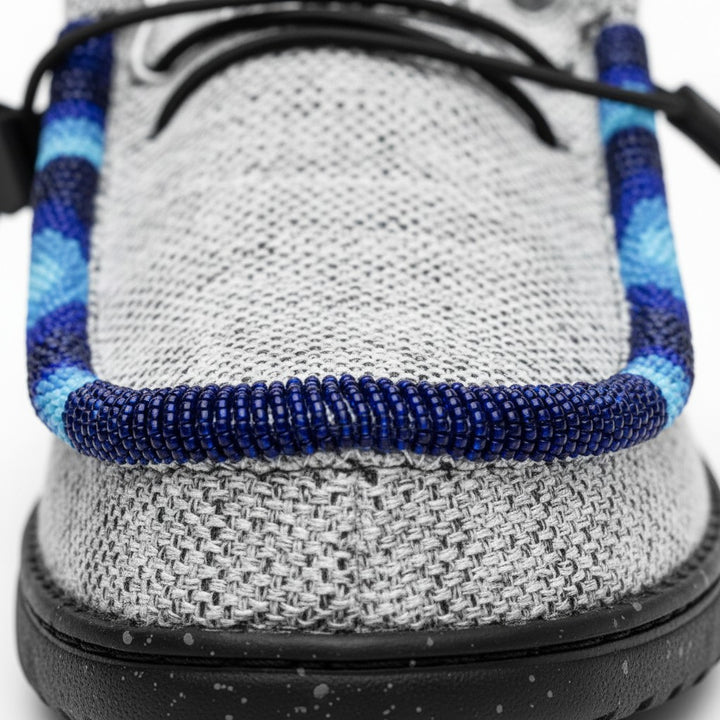 All Nations Designs &amp; More light gray mesh slip-on shoes featuring intricate blue hand-beaded trim detail