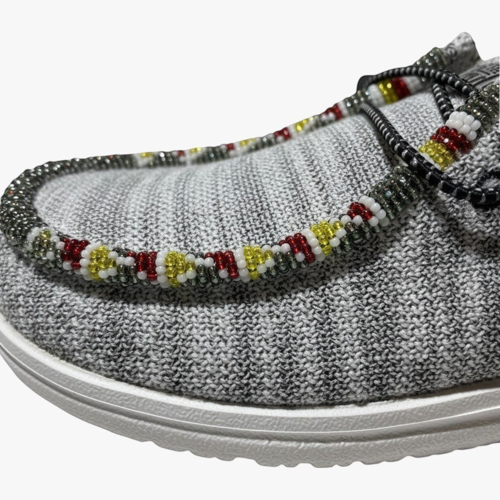 All Nations Designs &amp; More grey mesh Hey Dude slip-on shoes featuring intricate red, yellow, and metallic hand-beading.