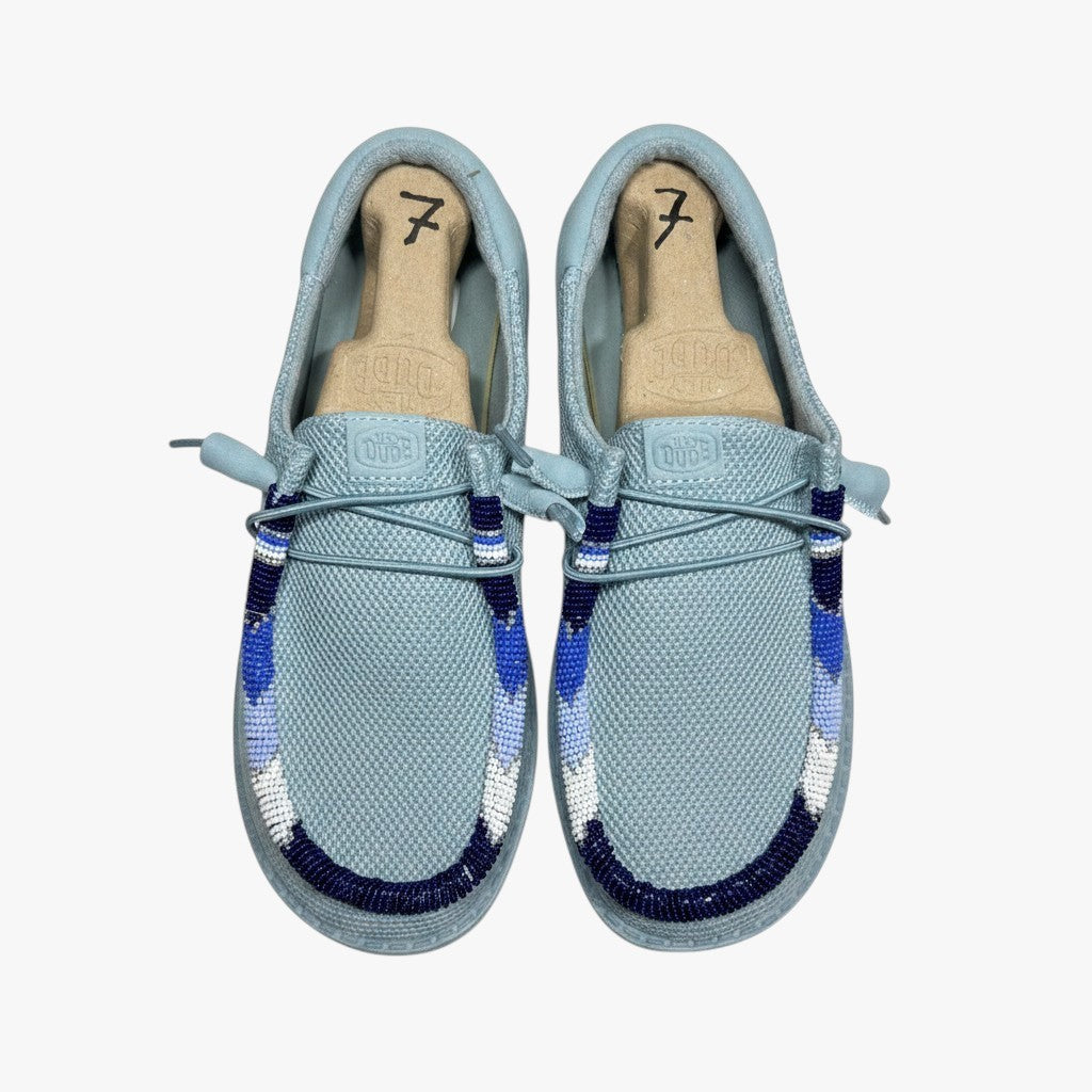 All Nations Designs & More hand-beaded Hey Dude slip-on shoes in mesh tourmaline blue with custom blue beadwork.