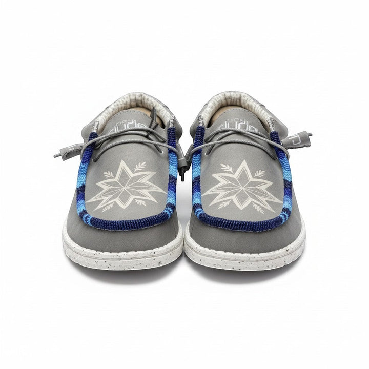 All Nations Designs &amp; More light gray Hey Dude slip-on shoes featuring custom blue hand-beaded trim and star design.