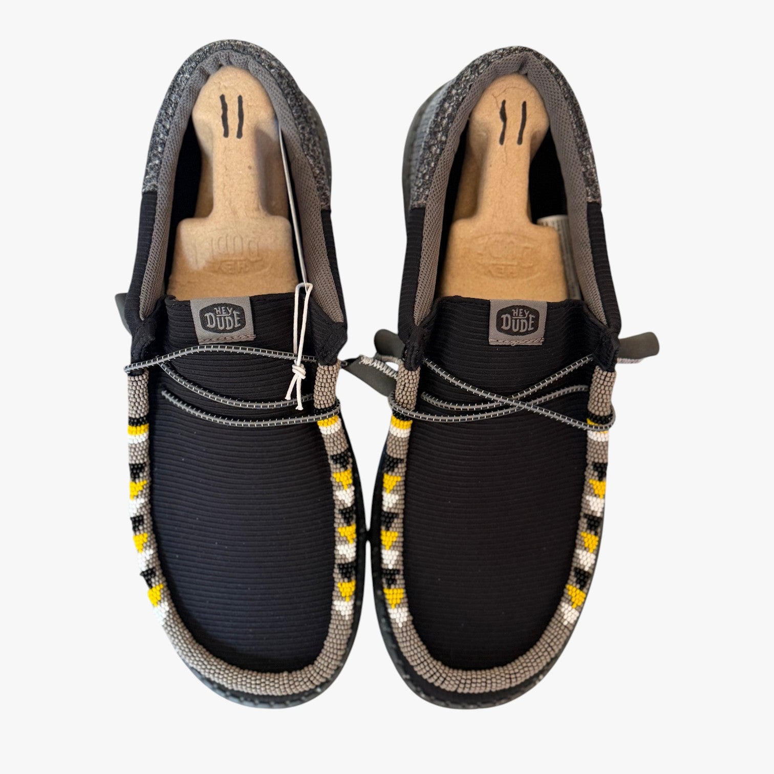 All Nations Designs & More men's black and gray Hey Dude slip-on shoes featuring custom hand-beaded trim details.