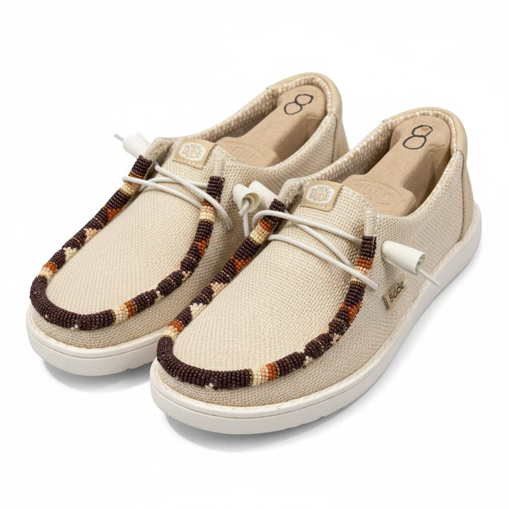 All Nations Designs &amp; More hand-beaded Hey Dude slip-on shoes in Irish cream mesh with brown and tan beadwork details.