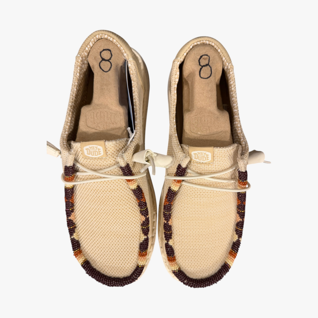 All Nations Designs &amp; More hand-beaded Hey Dude slip-on shoes in Irish cream mesh with brown and orange beadwork.