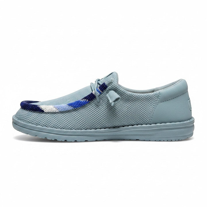 All Nations Designs &amp; More hand-beaded Hey Dude slip-on shoes in mesh tourmaline blue with custom beadwork detail.