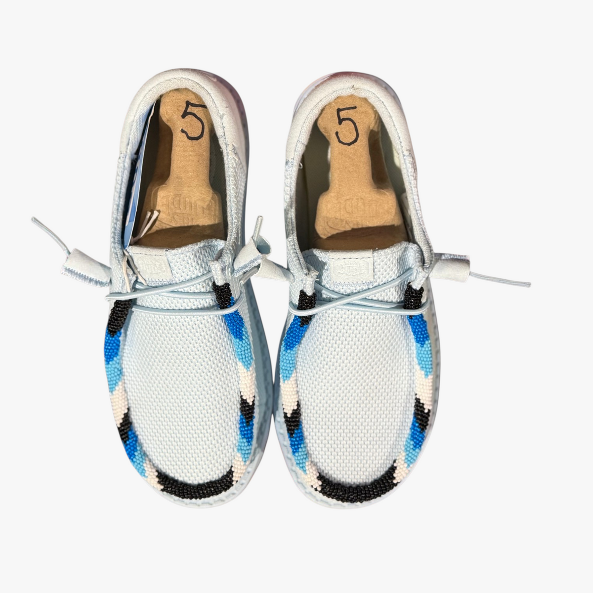 All Nations Designs & More women's size 5 Hey Dude slip-on shoes featuring custom blue, black, and white beadwork.
