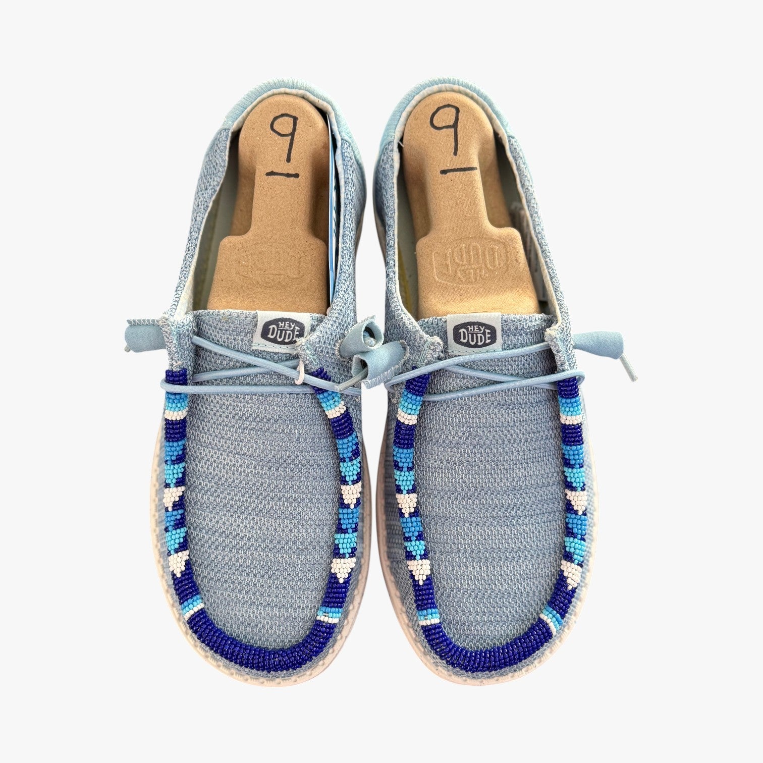 All Nations Designs & More hand-beaded gray and blue mesh Hey Dude slip-on shoes with unique western-inspired beadwork.