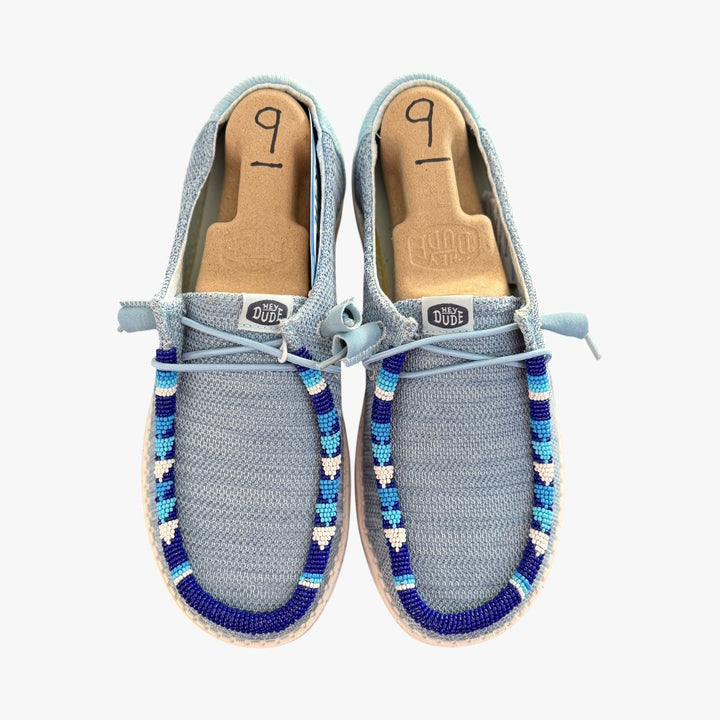 All Nations Designs &amp; More hand-beaded gray and blue mesh Hey Dude slip-on shoes with unique western-inspired beadwork.