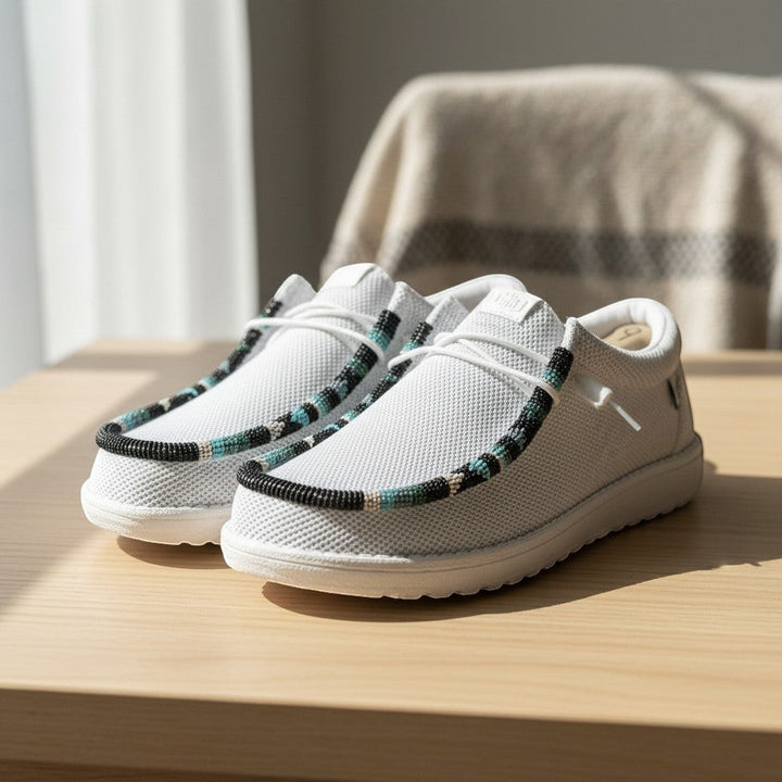 All Nations Designs &amp; More light gray mesh slip-on shoes featuring custom hand-beaded trim in turquoise and black.