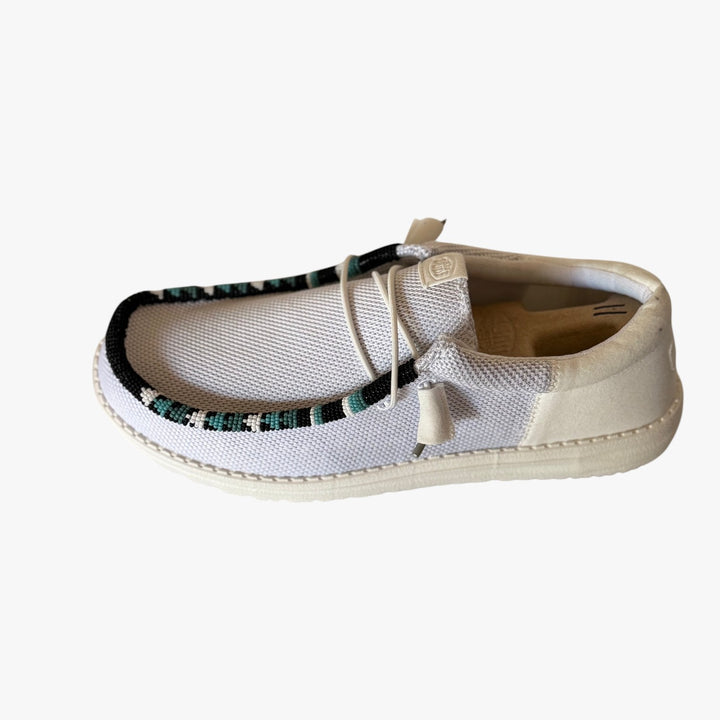 All Nations Designs &amp; More light gray mesh slip-on shoes featuring custom hand-beaded trim in a western-inspired pattern.