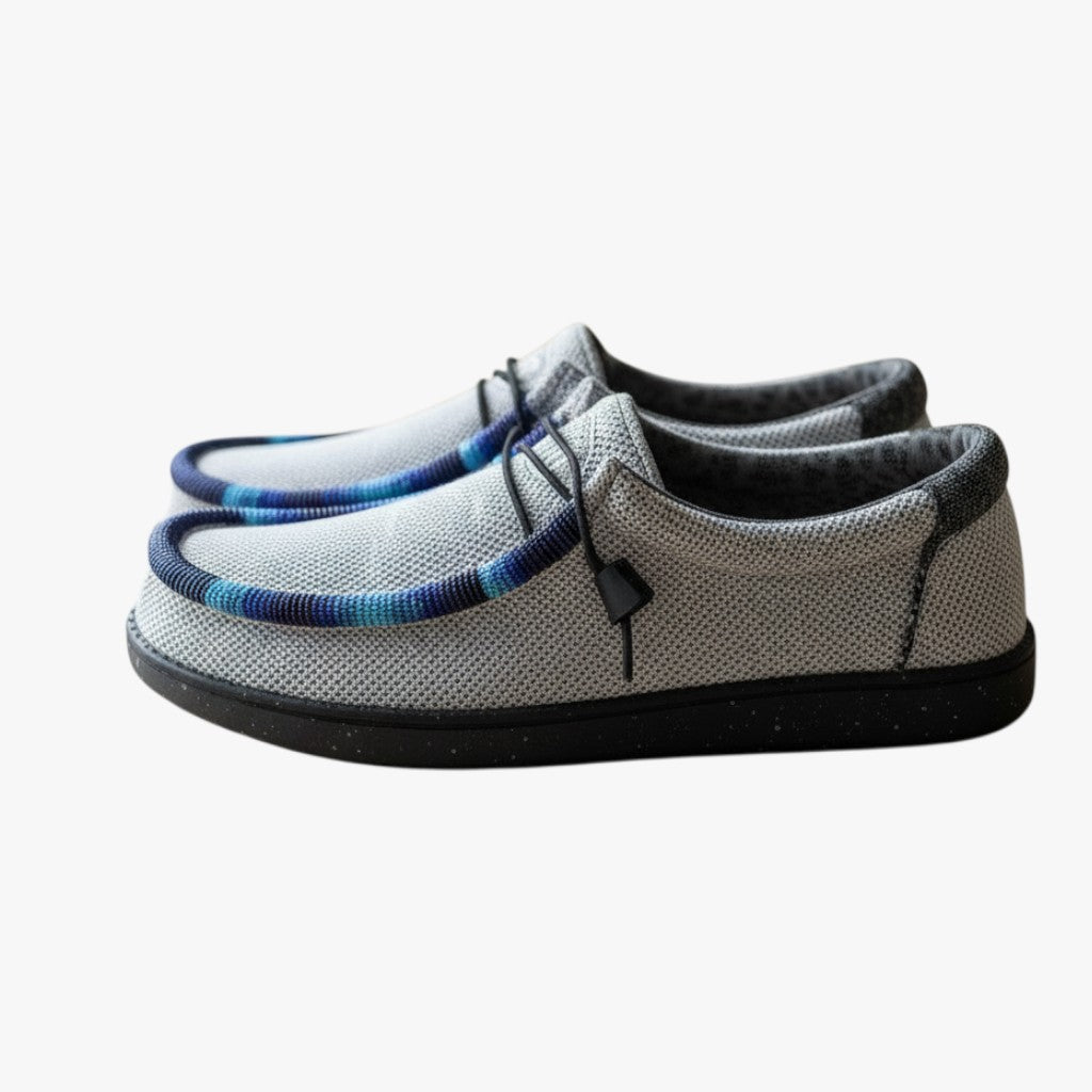 All Nations Designs &amp; More light gray mesh slip-on shoes with custom blue and purple hand-beaded trim on a table.