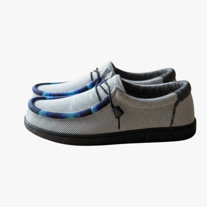 All Nations Designs &amp; More light gray mesh slip-on shoes with custom blue and purple hand-beaded trim on a table.