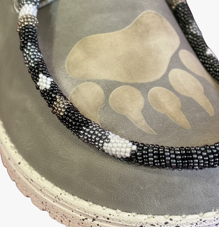 All Nations Designs &amp; More light gray Hey Dude slip-on shoes featuring custom black and white hand-beaded bear paw trim