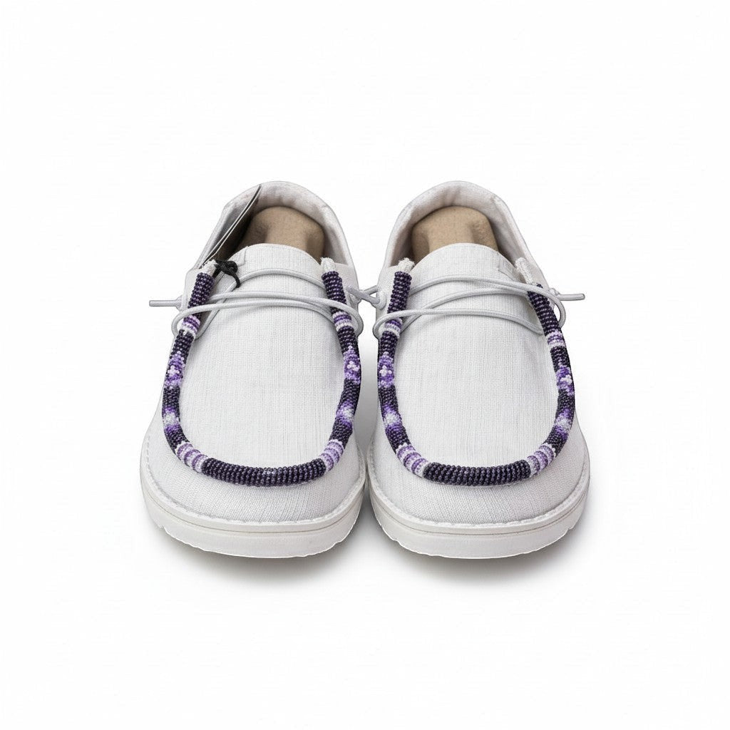 All Nations Designs &amp; More white Hey Dude slip-on shoes featuring unique purple and white hand-beaded lace detailing.