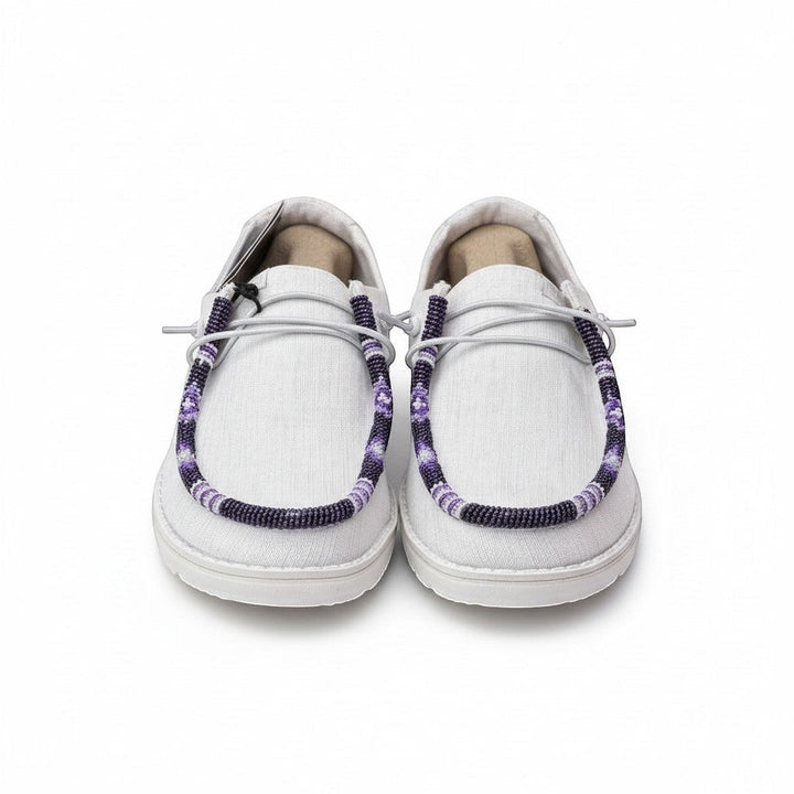 All Nations Designs &amp; More white Hey Dude slip-on shoes featuring unique purple and white hand-beaded lace detailing.