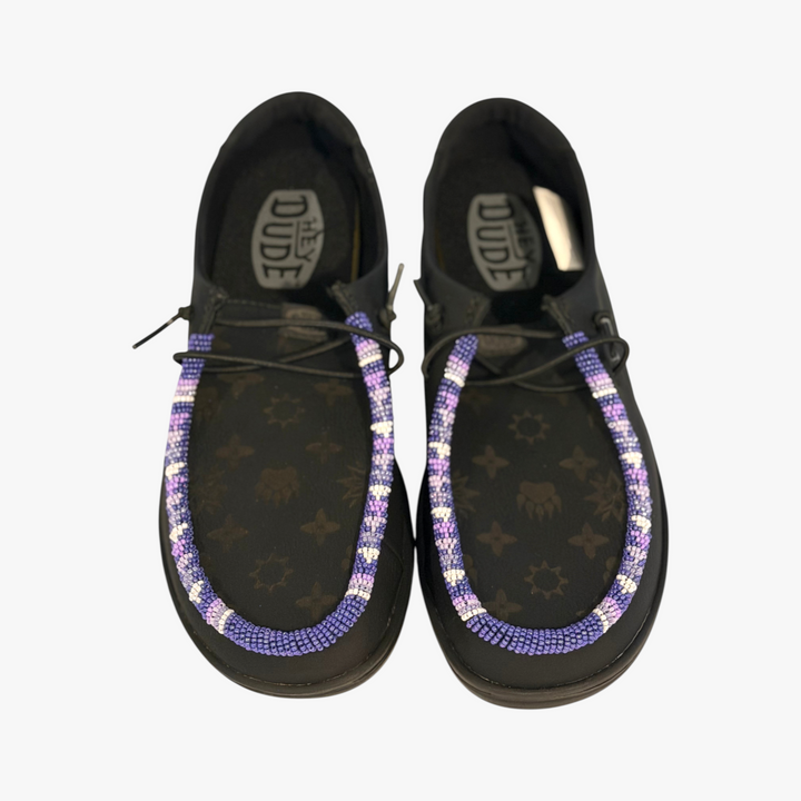 All Nations Designs &amp; More black Hey Dude leather slip-on shoes featuring custom purple and white hand-beaded trim.