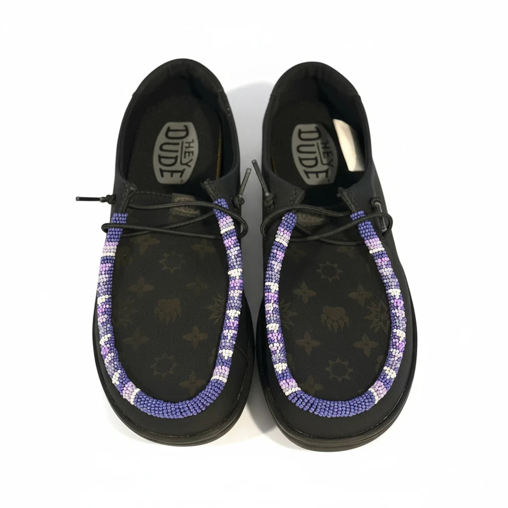 All Nations Designs &amp; More black Hey Dude leather slip-on shoes featuring custom purple and white hand-beaded trim