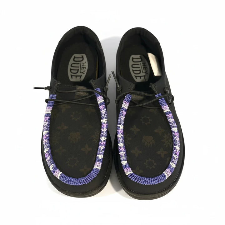All Nations Designs &amp; More black Hey Dude leather slip-on shoes featuring custom purple and white hand-beaded trim