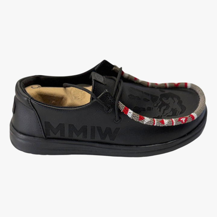 All Nations Designs &amp; More black Hey Dude slip-on shoes featuring laser-etched MMIW text and hand-beaded trim detail.