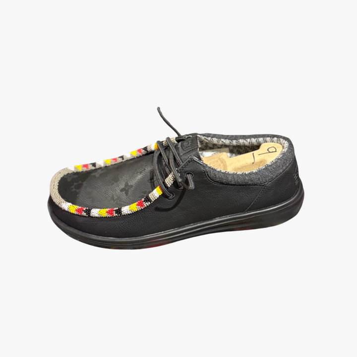 All Nations Designs &amp; More black Hey Dude slip-on shoes featuring custom hand-beaded trim and laser-etched details.