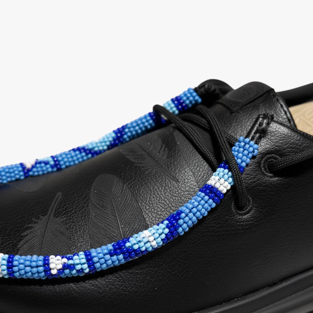 All Nations Designs &amp; More black Hey Dude slip-on shoes featuring custom blue and white hand-beaded lace detailing