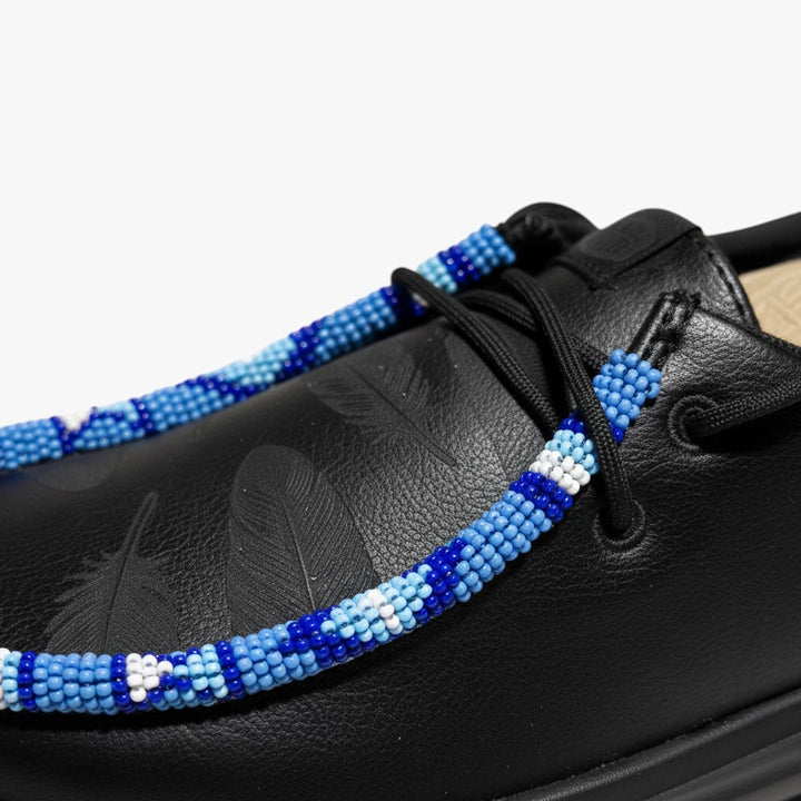 All Nations Designs &amp; More black Hey Dude slip-on shoes featuring custom blue and white hand-beaded lace detailing
