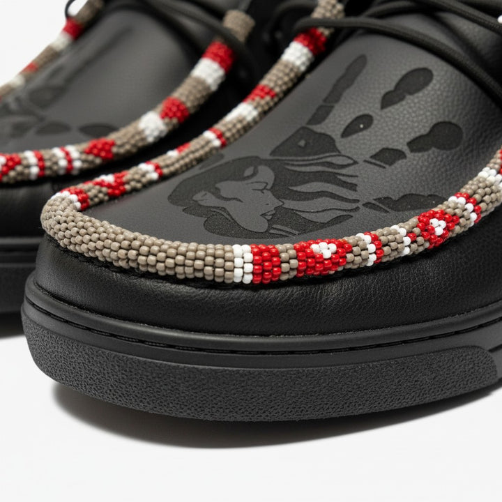 All Nations Designs &amp; More black Hey Dude slip-on shoes with laser-etched MMIW design and intricate hand-beaded trim.