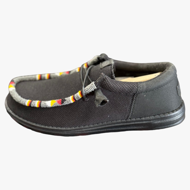 All Nations Designs &amp; More black mesh slip-on shoes featuring traditional hand-beaded trim in a side profile view.
