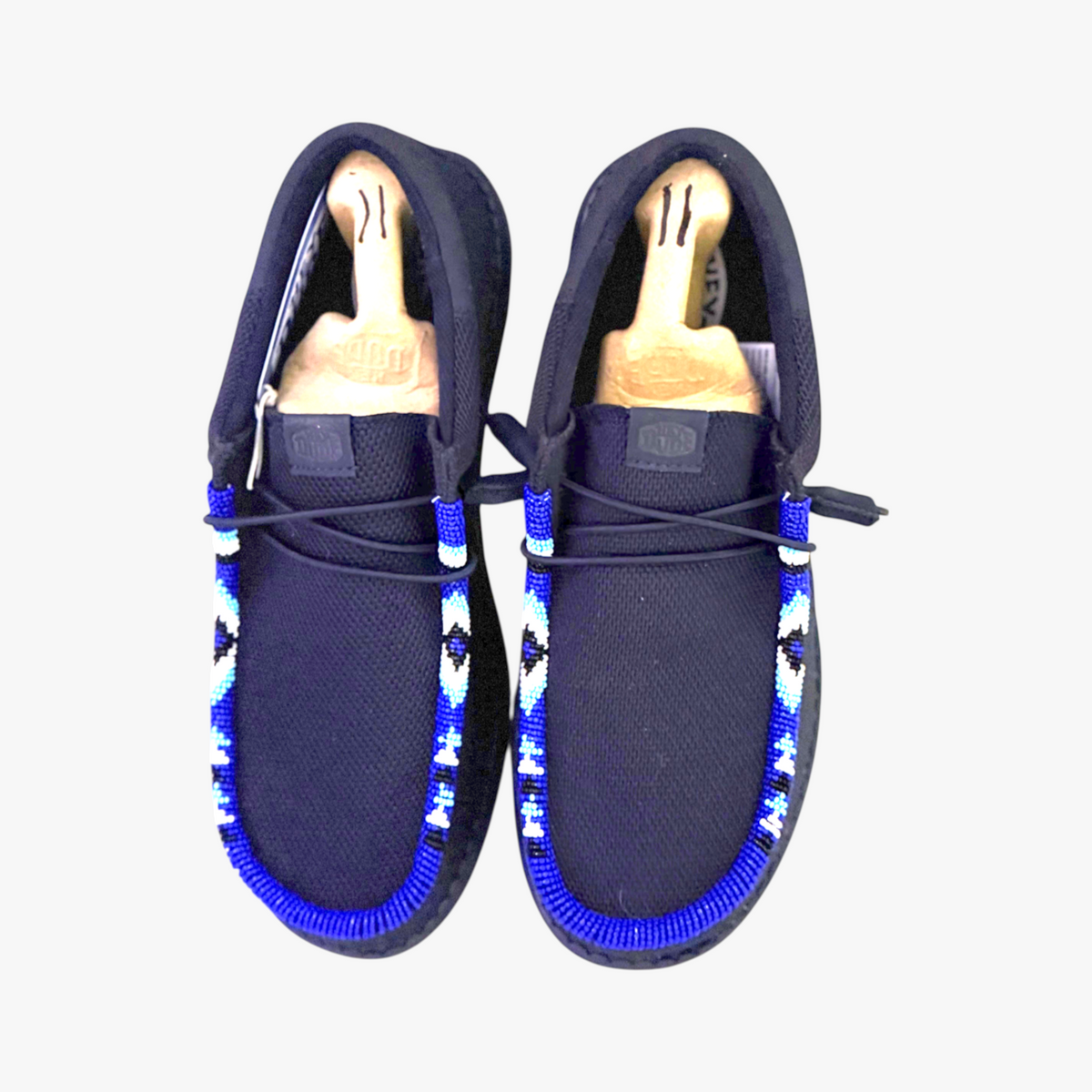 All Nations Designs & More men's black mesh slip-on shoes featuring custom blue, white, and black hand-beaded trim.