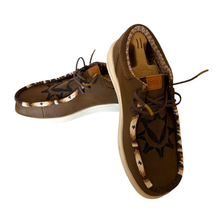 All Nations Designs &amp; More brown Hey Dude slip-on shoes featuring custom hand-beaded teepee and laser-etched designs.