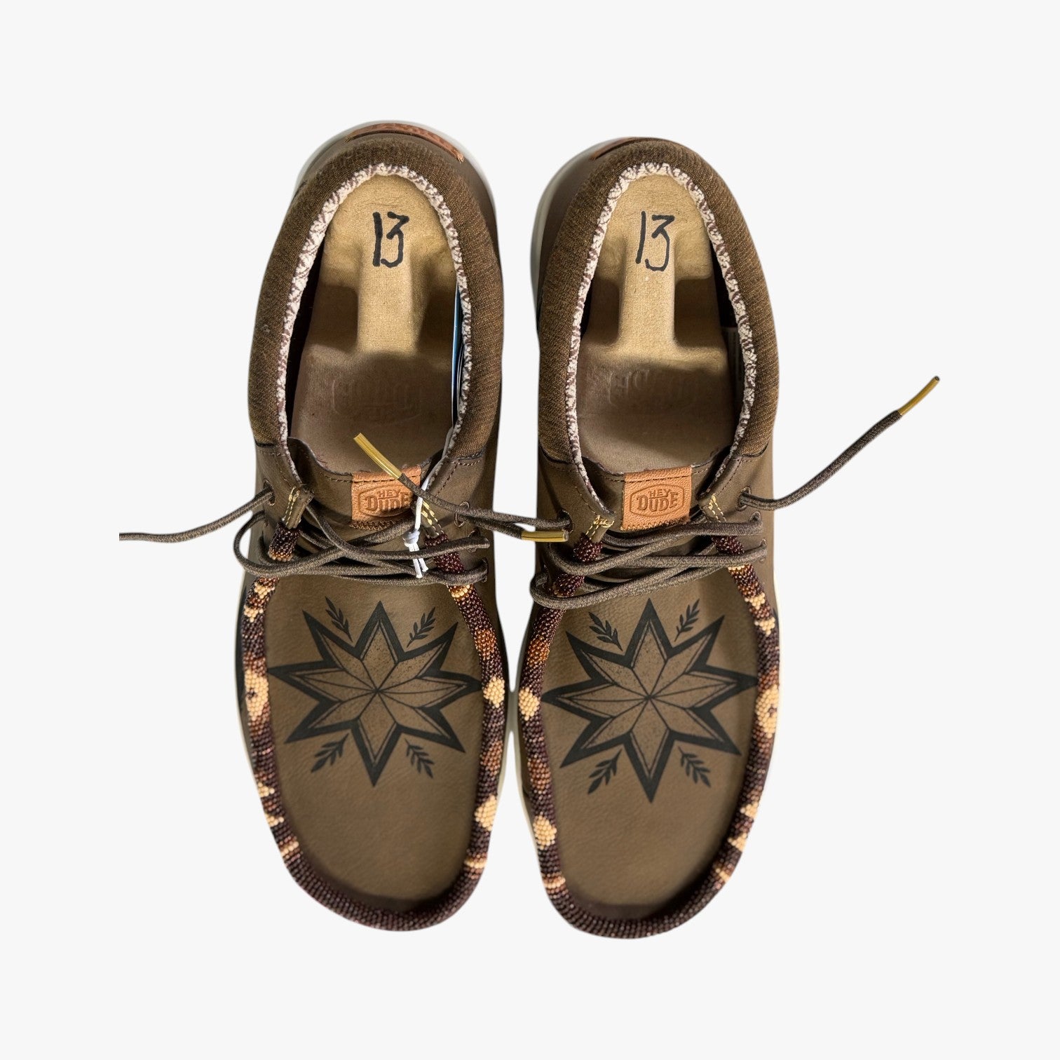 All Nations Designs & More men's brown Hey Dude slip-on shoes featuring custom hand-beaded star patterns