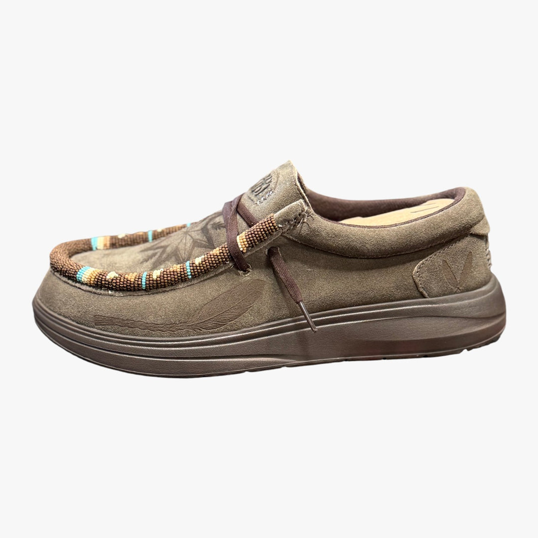 All Nations Designs &amp; More brown suede Hey Dude slip-on shoes featuring intricate hand-beaded detailing and laser-etched feather designs.