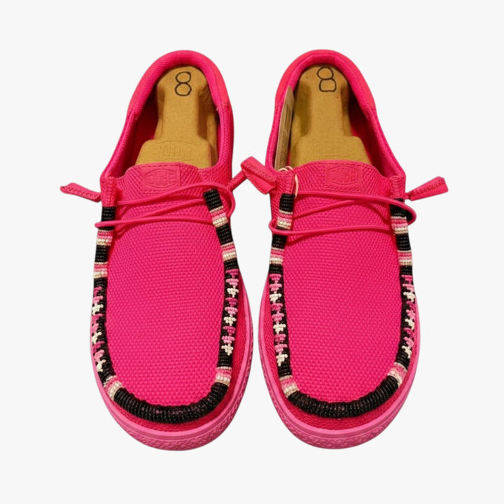 All Nations Designs &amp; More electric pink Hey Dude slip-on shoes featuring custom hand-beaded trim in a western style.