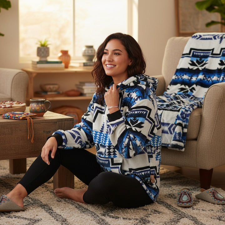 All Nations Designs &amp; More Geo-Storm hoodie with blue, white, and black Southwestern geometric pattern on a woman.