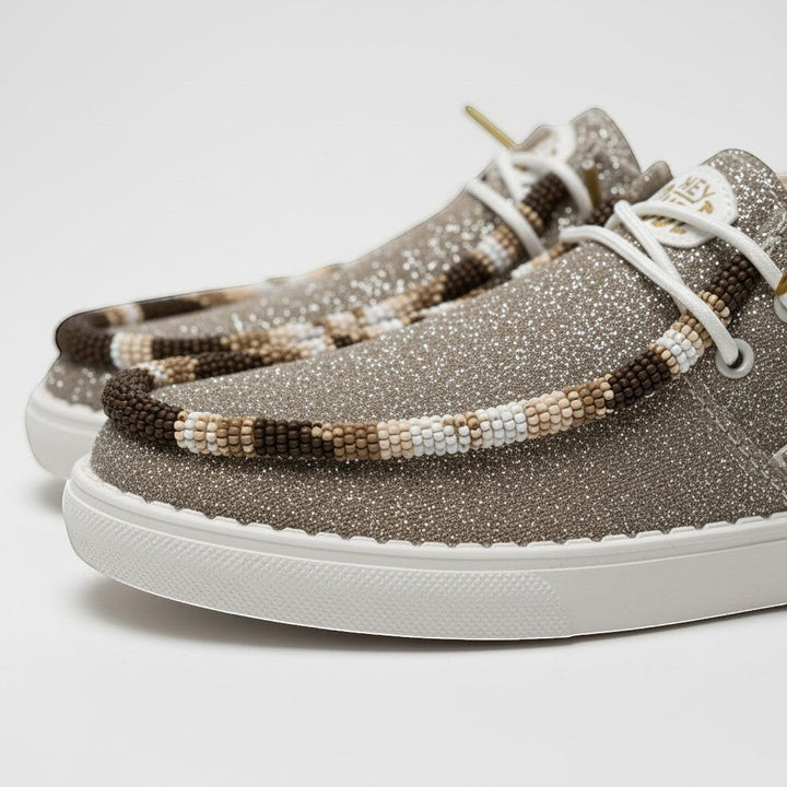 All Nations Designs &amp; More Hey Dude metallic gold sparkle slip-on shoes with intricate earthy hand-beaded trim.
