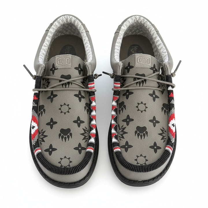 All Nations Designs &amp; More gray Hey Dude slip-on shoes featuring custom hand-beaded trim and black laser-etched patterns.