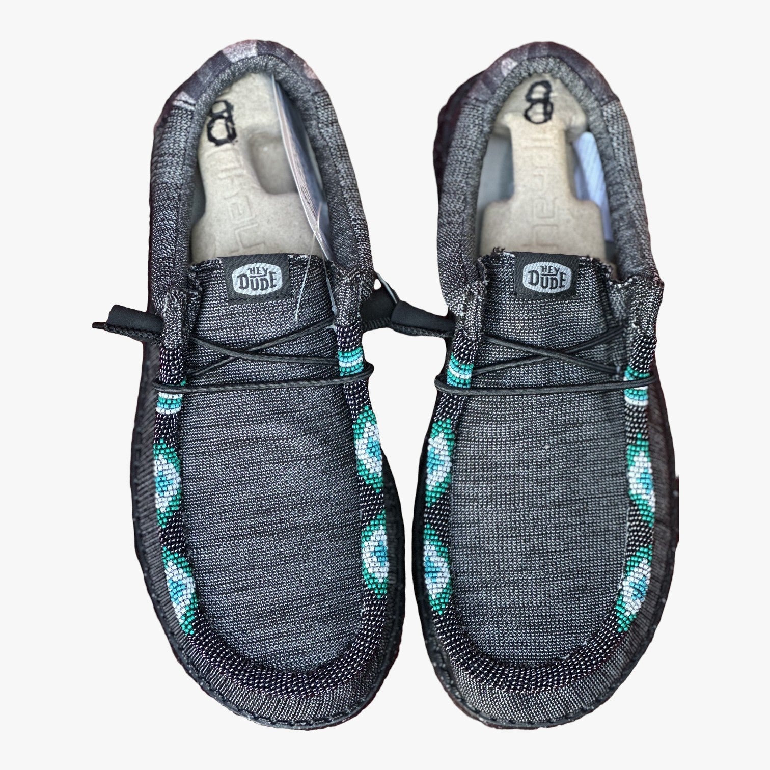 All Nations Designs & More gray Hey Dude slip-on shoes featuring custom turquoise and white hand-beaded detailing.