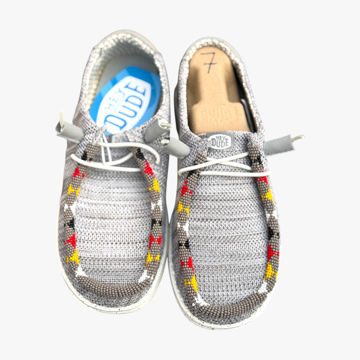 All Nations Designs & More gray mesh Hey Dude slip-on shoes featuring unique hand-beaded western-inspired patterns.