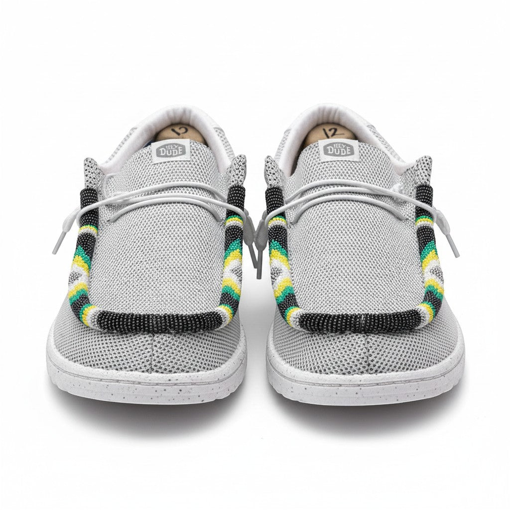All Nations Designs &amp; More gray mesh Hey Dude slip-on shoes featuring custom hand-beaded trim in yellow, green, and black.