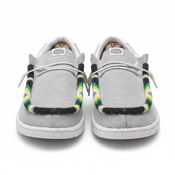 All Nations Designs &amp; More gray mesh Hey Dude slip-on shoes featuring custom hand-beaded trim in yellow, green, and black.