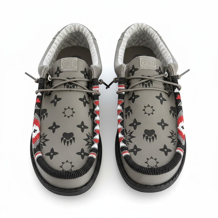 All Nations Designs &amp; More gray Hey Dude slip-on shoes featuring unique hand-beaded trim and western-inspired patterns.