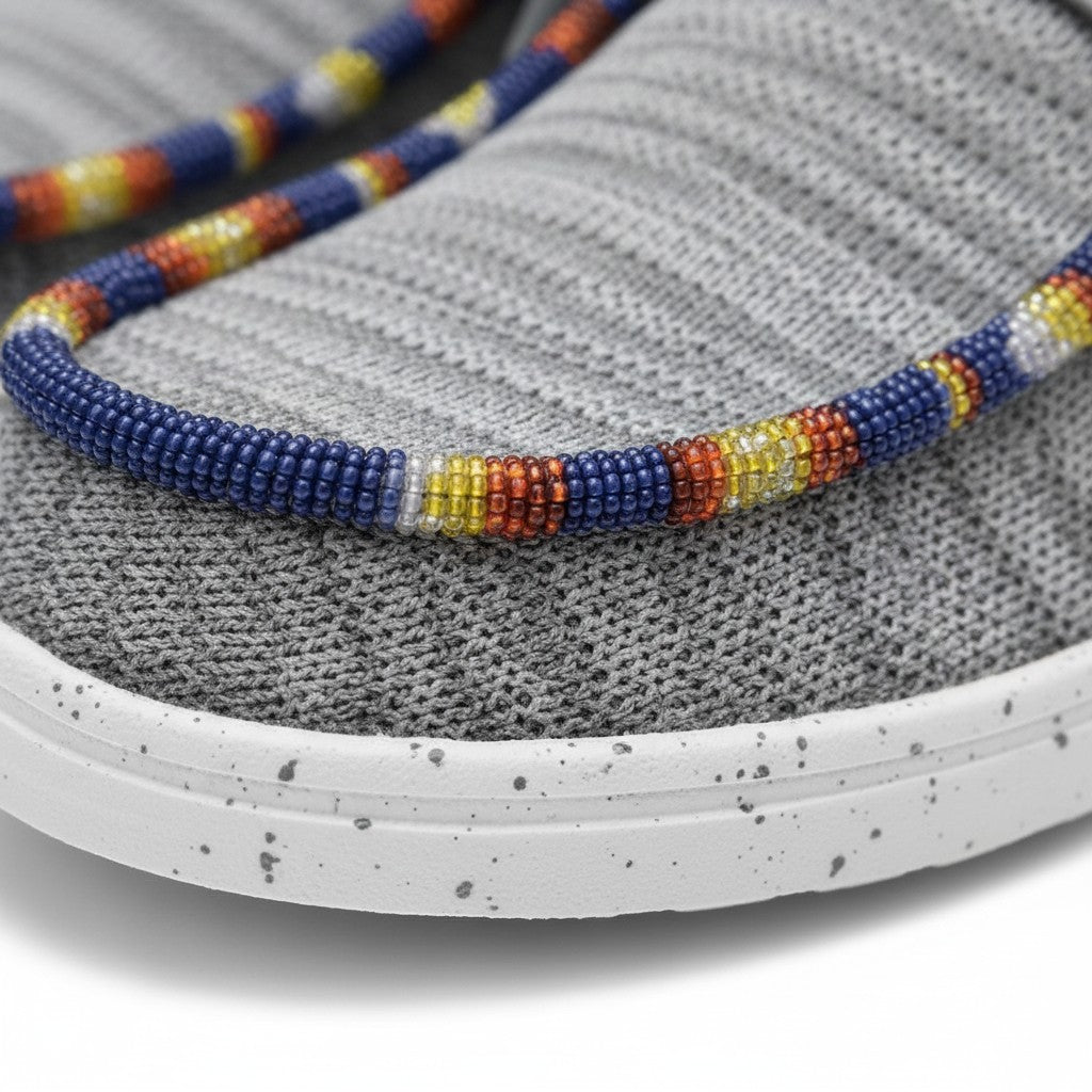 All Nations Designs &amp; More gray mesh slip-on shoes featuring intricate, colorful hand-beaded detailing on the toe.