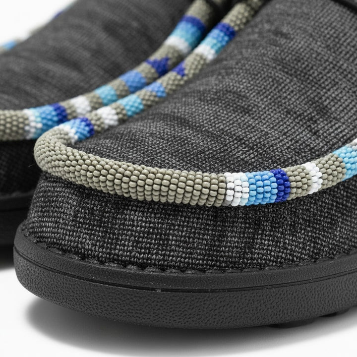 All Nations Designs &amp; More gray slip-on shoes featuring intricate blue and white hand-beaded trim detail.