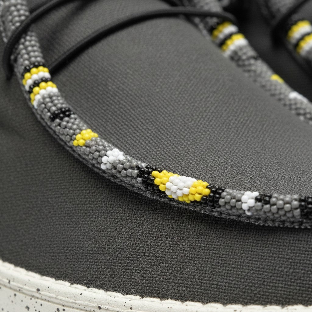All Nations Designs &amp; More gray mesh slip-on shoes featuring intricate yellow, white, and black hand-beaded detailing.