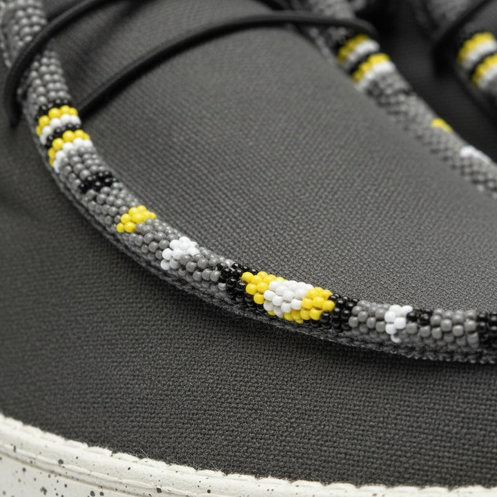 All Nations Designs &amp; More gray mesh slip-on shoes featuring intricate yellow, white, and black hand-beaded detailing.